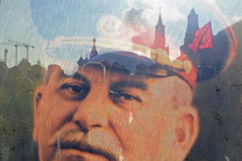 Russian Communists and their supporters are seen through a transparent portrait of Soviet dictator Josef Stalin as they lay flowers at his tomb at the Red Square in Moscow on March 5, 2013, to mark the 60th anniversary of Stalin's death. Photo by KIRILL KUDRYAVTSEV/AFP/Getty Images