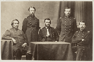 General Ulysses S. Grant and Staff: Ely Samuel Parker (left sitting), Adam Badeau, General Grant (at table), Orville Elias Babcock, Horace Porter. WIKIPEDIA