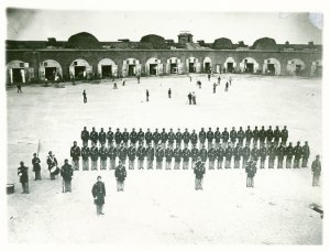 An early version of a baseball game took place in the background as members of the 48th New York State Volunteer Infantry lined up in Fort Pulaski, Ga., in 1862. Credit Western Reserve Historical Society
